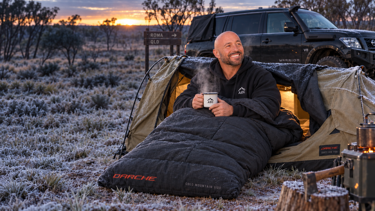 Leighton Calvert with a Darche Cold Mountain Canvas 1100 sleeping bag in a frost-covered Dirty Dee swag near Roma