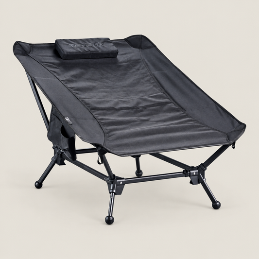 TIEGEAR BASE LOUNGER MIDNIGHT on warm stone background